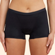 A model wears a pair of black Thinx boyshorts